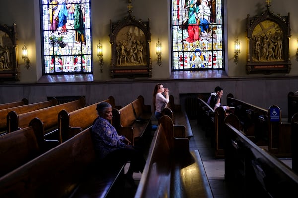 FILE - A parishioner prays at St. Peter the Apostle Catholic Church in Reading, Pa., June 16, 2024. (AP Photo/Luis Andres Henao, File)