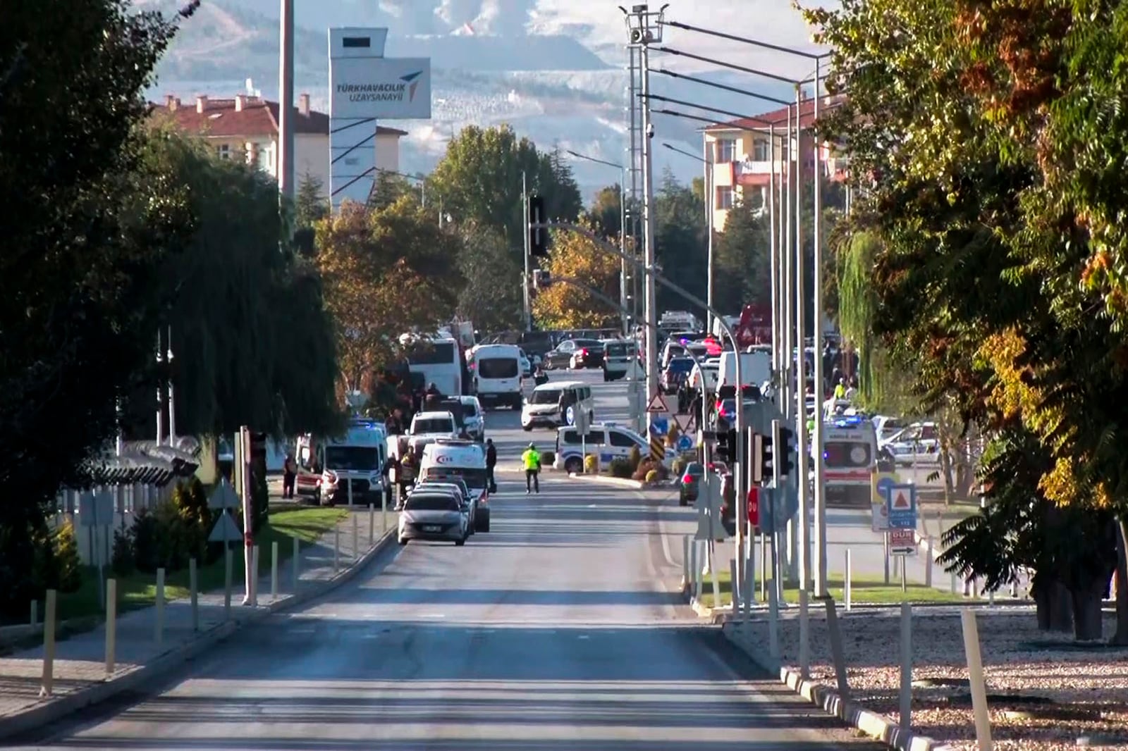 Emergency rescue teams and police officers work outside of Turkish Aerospace Industries Inc. on the outskirts of Ankara, Turkey, Wednesday, Oct. 23, 2024. (IHA via AP)