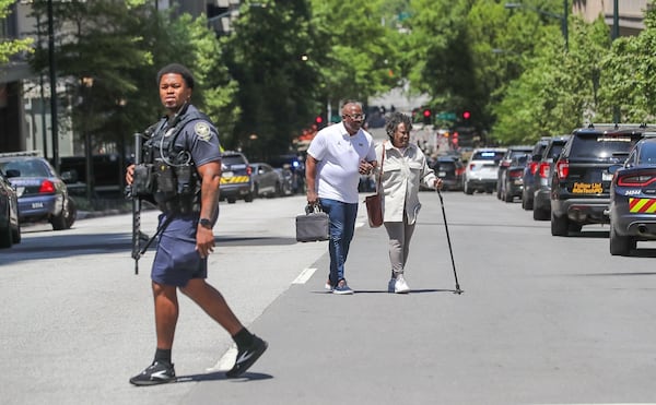 KJ Johnson (center), a U.S. Air Force veteran, helped a woman named Doris (right) down nine flights of stairs to safety after the shooting Wednesday at Northside Hospital Midtown medical center.