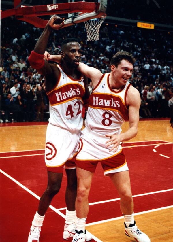 Hawks Kevin Willis (left) and Alexander Volkov celebrate a win over the Philadelphia 76ers in 1992. (RICH ADDICKS/AJC staff)