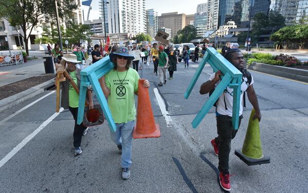 Protesters march on Peachtree Road near Buckhead MARTA transit station during Southeast Climate Strike and Rebellion on Friday, September 27, 2019. 