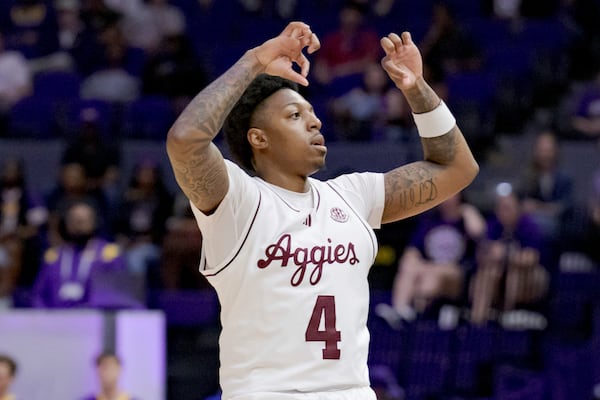 Texas A&M guard Wade Taylor IV (4) reacts after a three-point basket against LSU during the first half of an NCAA college basketball game in Baton Rouge, La., Saturday, March 8, 2025. (AP Photo/Matthew Hinton)