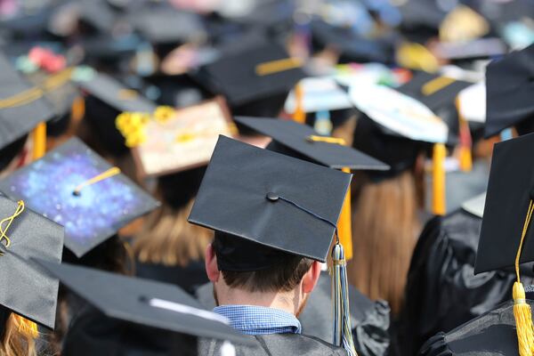 FILE - In this May 5, 2018, file photo, students attend the University of Toledo commencement ceremony in Toledo, Ohio. Colleges across the U.S. have begun cancelling and curtailing spring graduation events amid fears that the new coronavirus will not have subsided before the stretch of April and May when schools typically invite thousands of visitors to campus to honor graduating seniors. (AP Photo/Carlos Osorio, File)