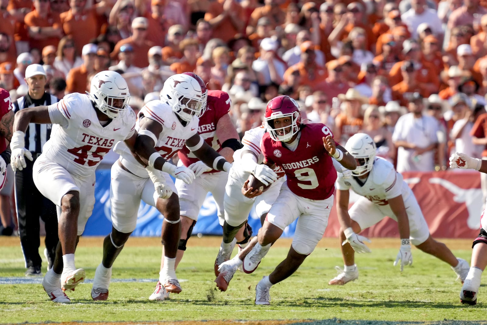 Oklahoma quarterback Michael Hawkins Jr. (9) is stripped of the ball by Texas in the second half of an NCAA college football game in Dallas, Saturday, Oct. 12, 2024. (AP Photo/Jeffrey McWhorter)