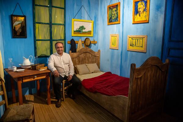 Producer and creative director Mario Iacampo sits inside a recreation of  Vincent van Gogh's bedroom, one of the exhibits, at the new show "Van Gogh: The Immersive Experience." STEVE SCHAEFER FOR THE ATLANTA JOURNAL-CONSTITUTION