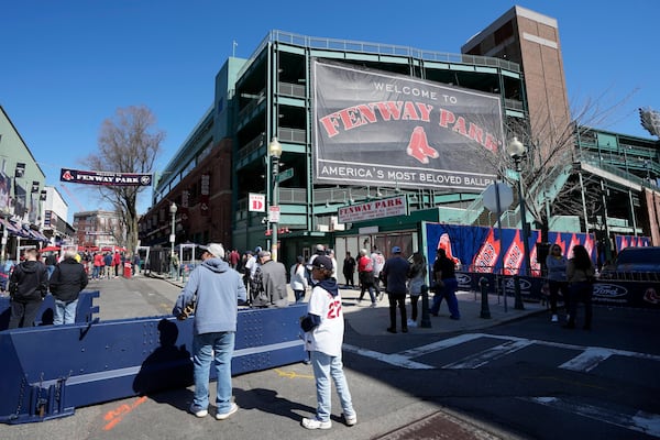 Fans outside Fenway Park before an opening-day baseball game between the Boston Red Sox and the Baltimore Orioles, Tuesday, April 9, 2024, in Boston. (AP Photo/Michael Dwyer)