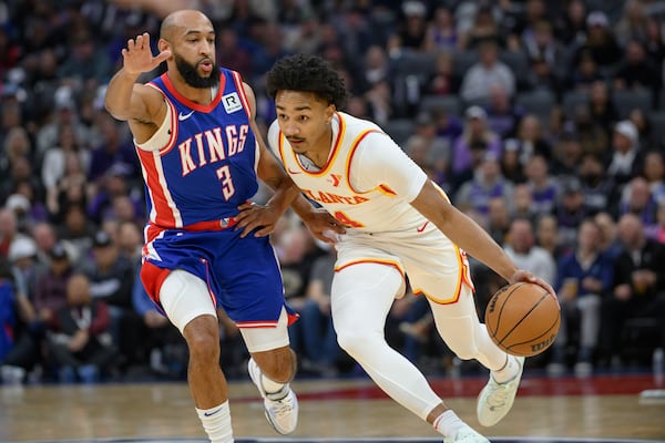 Atlanta Hawks guard Kobe Bufkin, right, is guarded by Sacramento Kings guard Jordan McLaughlin (3) during the first half of an NBA basketball game in Sacramento, Calif., Monday, Nov. 18, 2024. (AP Photo/Randall Benton)