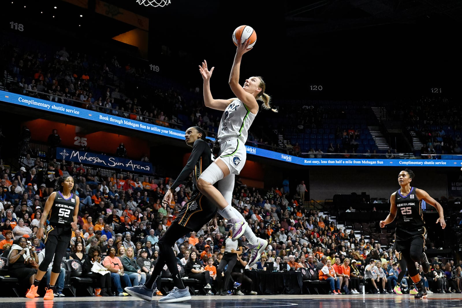 Minnesota Lynx forward Alanna Smith goes up for a basket as Connecticut Sun forward DeWanna Bonner defends during the first half of Game 4 in the WNBA basketball semifinals, Sunday, Oct. 6, 2024, in Uncasville, Conn. (AP Photo/Jessica Hill)