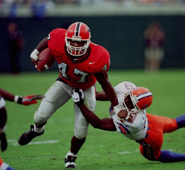 Georgia's Robert Edwards (47) pulls away from Florida's Anthone Lott (9) on November 2, 1996 in Jacksonville. (Frank Niemeir / AJC) 