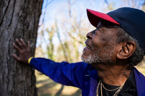 Fernando Jones touches the tree he fell from as a child at the site of the old Carrie Steele-Pitts Home in Atlanta, Georgia on Monday, Feb, 3, 2025. (Olivia Bowdoin for the AJC). 