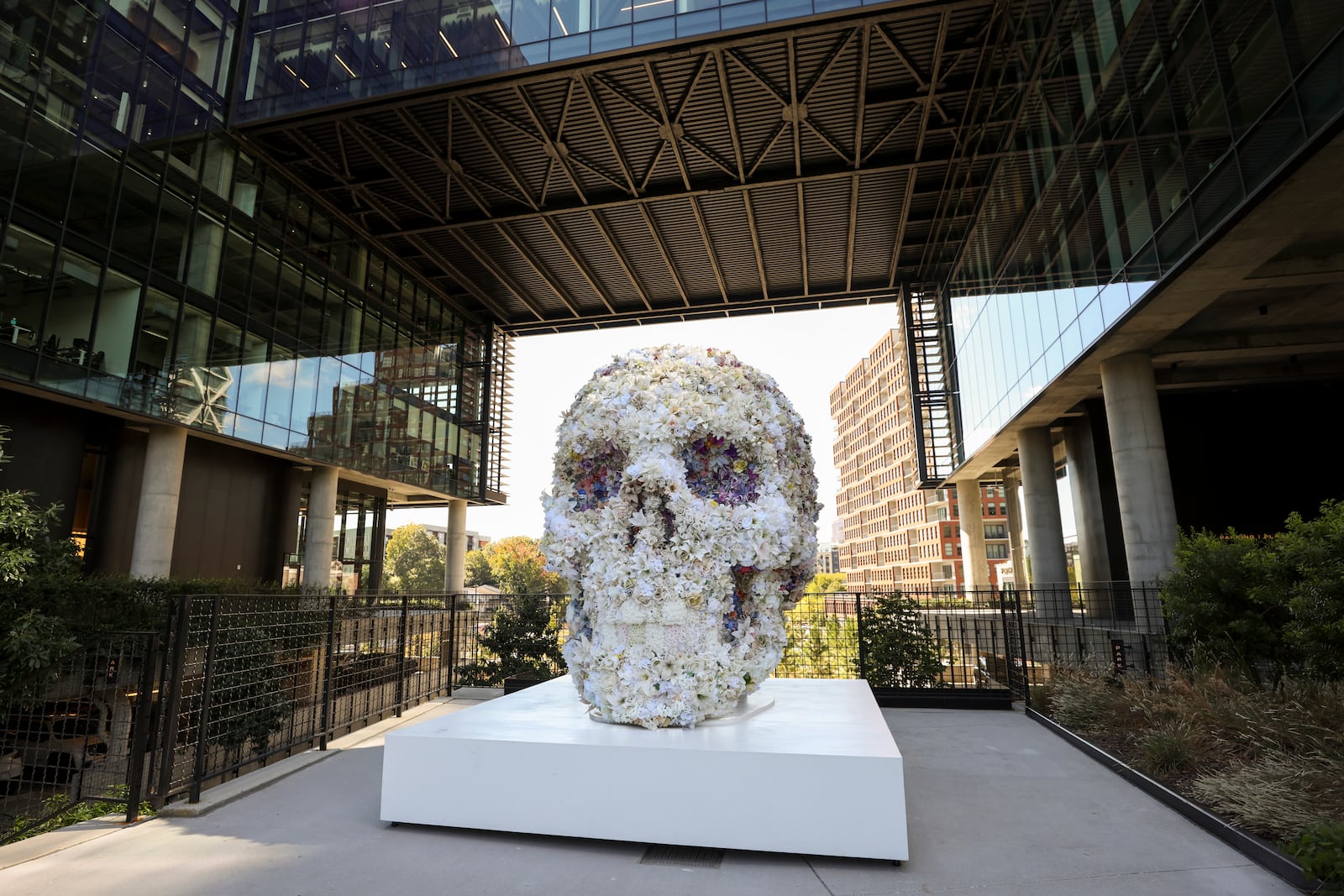 An art installation of a giant skull made of flowers is shown near the Old Fourth office buildings along the Eastside Beltline Trail, Wednesday, October 16, 2024, in Atlanta. (Jason Getz / AJC)

