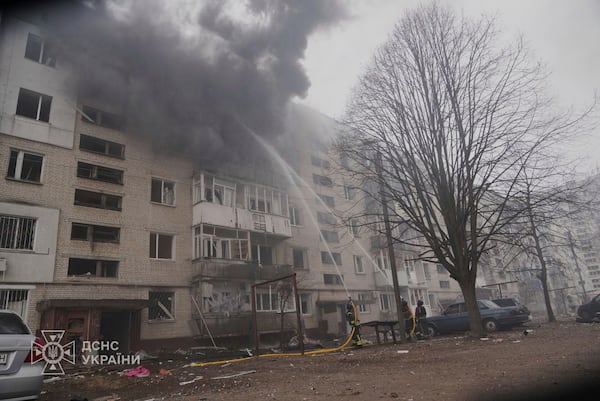 In this photo provided by the Ukrainian Emergency Service, firefighters put out the fire following a Russian attack in Sumy, Ukraine, Tuesday, March 25, 2025. (Ukrainian Emergency Service via AP)