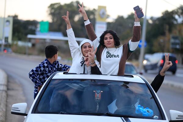 People celebrate after a ceasefire between Israel and Hezbollah went into effect in Sidon, Lebanon, Wednesday, Nov. 27, 2024. (AP Photo/Mohammed Zaatari)