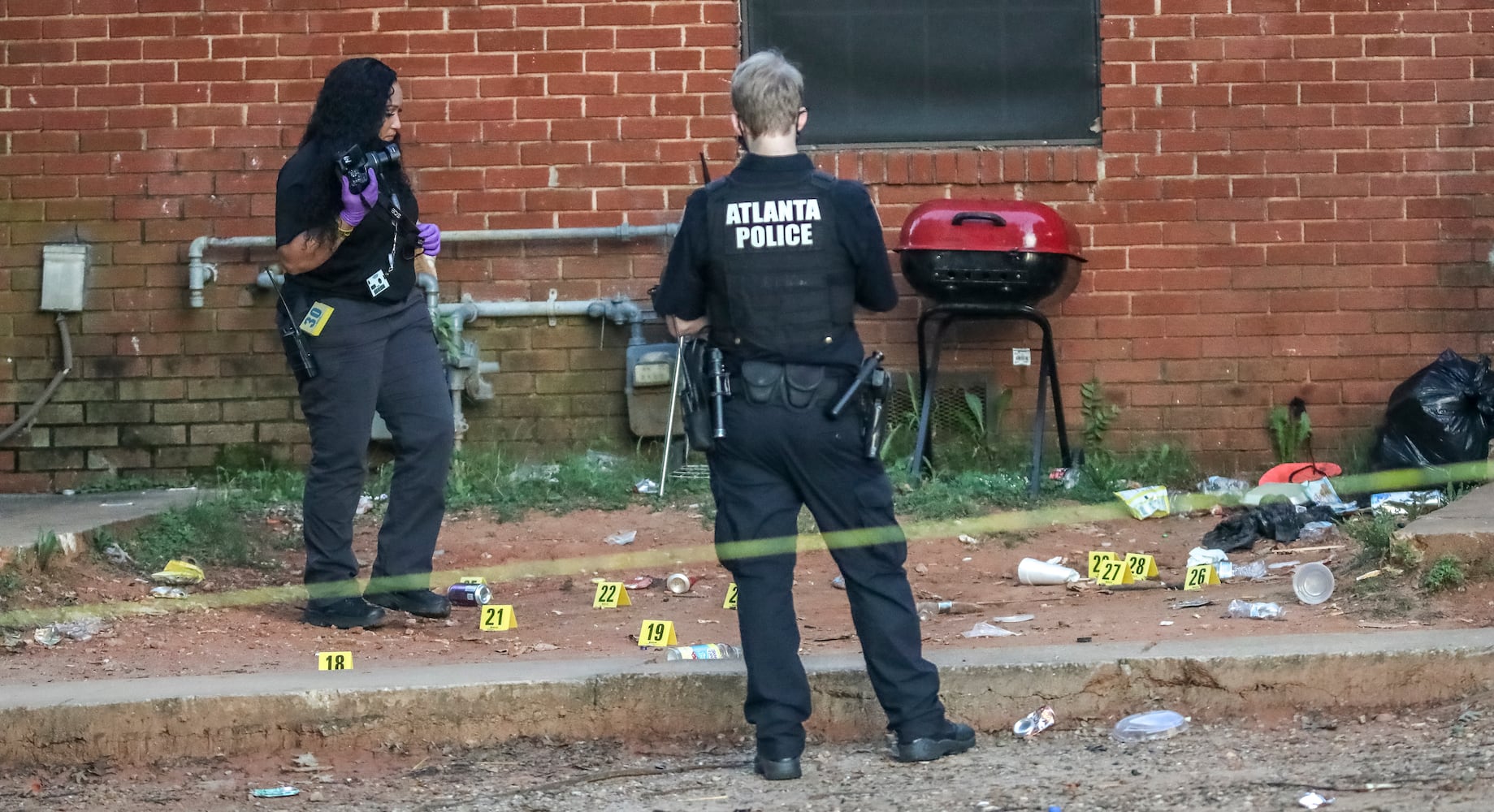 July 18, 2022 Atlanta: Five people were shot early Monday, July 18, 2022 when gunfire erupted at a large gathering at a condemned apartment complex in southeast Atlanta, police said. The shootings took Atlanta police officers to the Forest Cove Apartments in the Thomasville Heights neighborhood shortly before 2 a.m. According to deputy police Chief Charles Hampton Jr., the victims range in age from 13 to 42. One was taken to a hospital in a private vehicle before officers arrived, and none was interviewed by investigators before undergoing treatment, Hampton said. At least one, an unnamed teenager, remains in “very critical condition,” he said. “Officers are on scene trying to comb (through) exactly what happened,” Hampton said Monday from the complex. “We know there was quite a large gathering when some individuals came to this location and started shooting. Right now, we are asking anyone who was out here to call Crime Stoppers, where they can remain anonymous, to let us know exactly what happened.” Police took in several people for questioning, but no one was being detained as a suspect early Monday, he said. The deputy chief was hopeful that interviews with the victims would help them develop a suspect description. Early in the investigation, detectives are not sure if they are looking for multiple gunmen, or if the gunfire came from a vehicle or someone on foot. More than one victim resided at the complex, according to Hampton. Last month, the city of Atlanta began relocating families from Forest Cove ahead of demolition Sept. 21, but officials said last week the process is behind schedule. The blighted complex has been the site of at least 231 code violations and more than 650 police calls for violent crime, according to court documents filed by the city last year. Fulton County District Attorney Fani Willis has identified Forest Cove as one of the worst apartment complexes for gang activity and vowed to crack down on offenders. It was listed among 43 properties with the highest number of crimes and housing code violations for poor living conditions, as released by Atlanta City Solicitor Raines Carter. Since 2009, Atlanta police have investigated 19 homicides there. Monday’s multiple shootings remain under investigation. Tipsters can remain anonymous, and be eligible for rewards of up to $2,000, by contacting Crime Stoppers Atlanta at 404-577-8477, texting information to 274637 or visiting  (John Spink / John.Spink@ajc.com)


