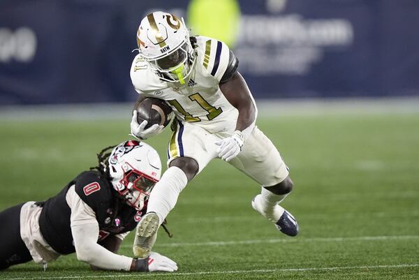 Georgia Tech running back Jamal Haynes (11) runs the ball against North Carolina State linebacker Sean Brown (0) during the second half of an NCAA college football game, Thursday, Nov. 21, 2024, in Atlanta. (AP Photo/Brynn Anderson)