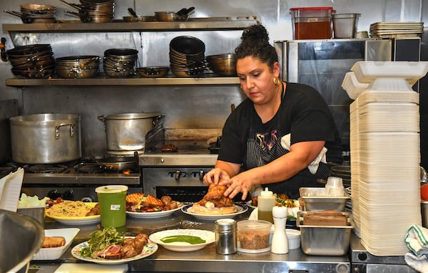 Khoury plates another order of chicken and waffle. AAJC082122SLAATLCULINARYJOURNEY (CHRIS HUNT FOR THE ATLANTA JOURNAL-CONSTITUTION)