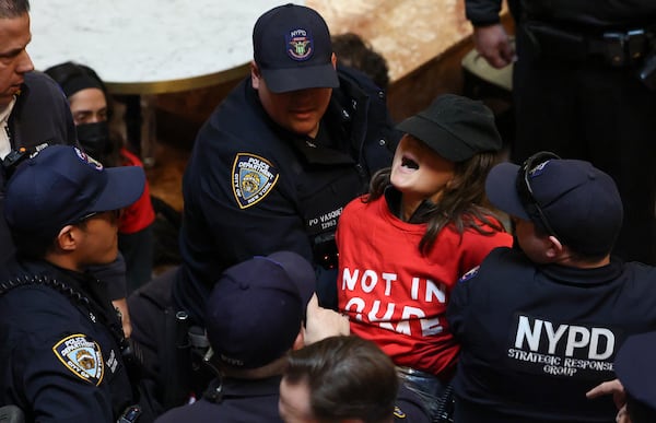 New York Police officers arrest a demonstrator from the group, Jewish Voice for Peace, who protested inside Trump Tower in support of Columbia graduate student Mahmoud Khalil, Thursday, March 13, 2025, in New York. (AP Photo/Yuki Iwamura)