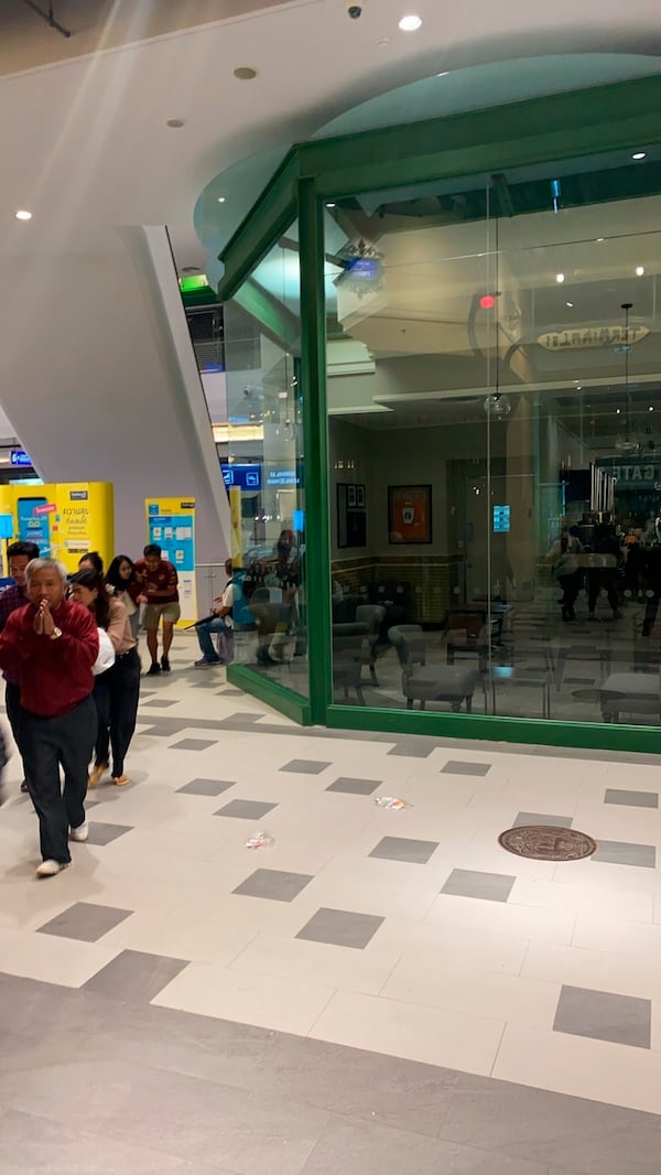 People are seen walking inside the Terminal 21 Korat mall on Saturday.