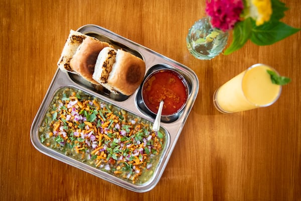 Chai Pani Misal Pav, sprouted mung bean curry, crunchy snack mix, onions, and cilantro, served with lime, pav and rassa. (Mia Yakel for The Atlanta Journal-Constitution)