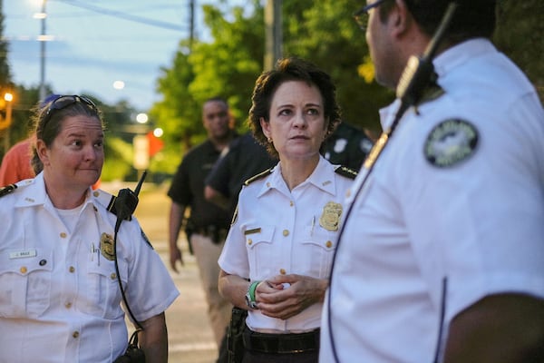 Atlanta Police Chief Erika Shields (center) huddles with officers on Briarcliff Road in Atlanta as protesters marched through Virginia-Highland past curfew on Friday, June 5, 2020. Just over a week later, Shields would step down from her post. (Photo: Ben Gray for The Atlanta Journal-Constitution)