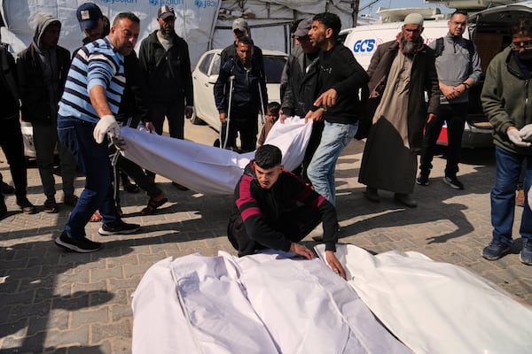 Mourners carry the bodies of Palestinians killed in the Israeli bombardment of the Gaza Strip as they are brought for burial Deir al-Balah, Gaza, on Tuesday, March 25, 2025. (AP Photo/Abdel Kareem Hana)