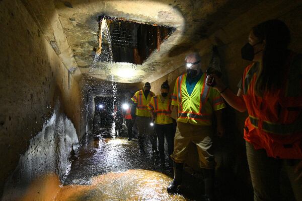 Georgia DNR biologist Emily Ferrall (right) leads trainees on a search for tricolor bats inside a culvert near Cartersville on Thursday, May 3, 2023. (Hyosub Shin / Hyosub.Shin@ajc.com)