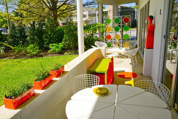 A tall, 1960s three-piece screen, made of steel and glass, separates the patio from the street. The colorful screen is one of the homeowner's favorite art pieces.