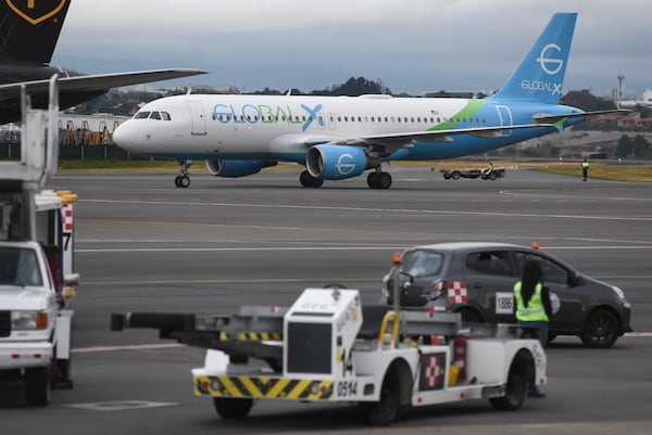 A plane carrying migrants from Central Asia and India, deported from the United States, arrives at Juan Santamaría International Airport in San Jose, Costa Rica, Thursday, Feb. 20, 2025. (AP Photo/Jose Diaz)