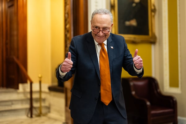 
                        Senate Majority Leader Chuck Schumer (D-N.Y.) flashes a thumbs-up after announcing that the Senate reached an agreement to pass the stopgap spending bill, at the Capitol in Washington, late on Friday, Dec. 20, 2024. The Senate approved a spending measure early Saturday to keep government money flowing through mid-March, sending it to President Joe Biden for his expected signature and closing a chaotic endgame in Congress minutes after federal funding had lapsed. (Eric Lee/The New York Times)
                      