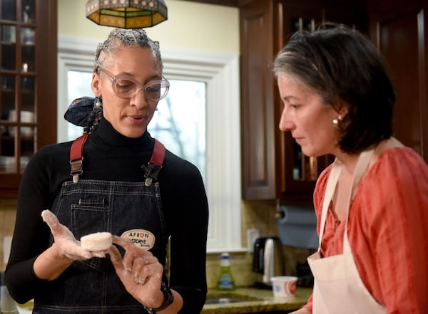 February 22, 2019 Atlanta - Top Chef Carla Hall (left) shows the AJC's Ligaya Figueras the texture of a good biscuit. Ligaya hosted Hall and food expert Chadwick Boyd at her home, where the two shared tips on how to make the best biscuits. RYON HORNE / RHORNE@AJC.COM