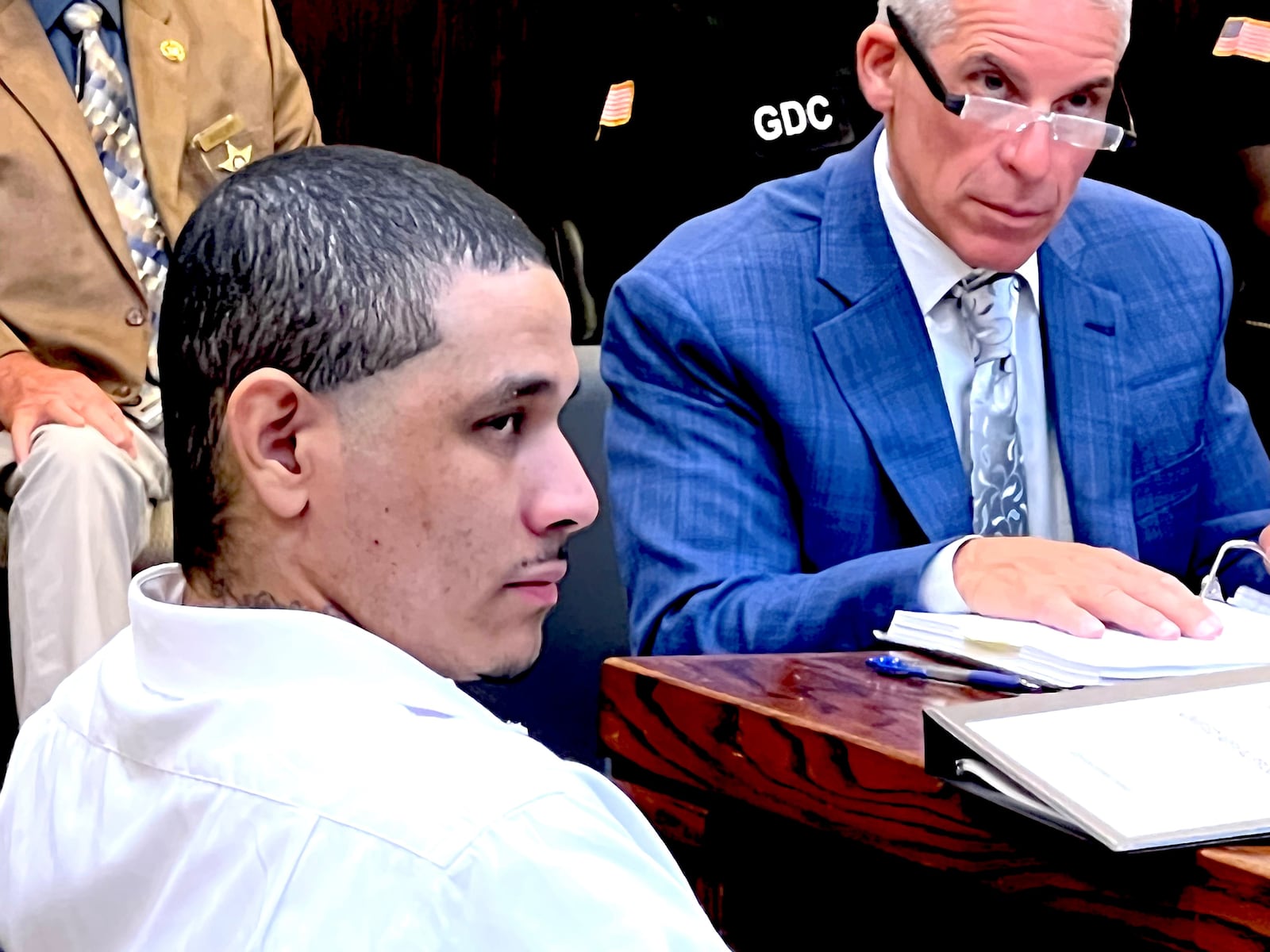 Nathan Weekes, accused of ordering a hit on a correctional officer in January 2021 that resulted in the shooting death of 88-year-old Glennville resident Bobby Kicklighter, listens in a Tattnall County courtroom as prosecutors discuss the death penalty. (Lewis Levine)