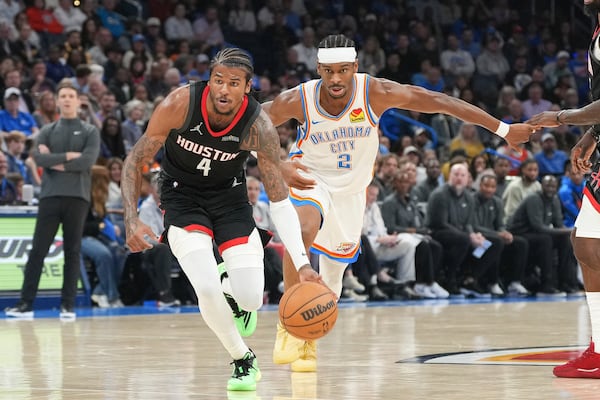 Houston Rockets guard Jalen Green (4) drives past Oklahoma City Thunder guard Shai Gilgeous-Alexander (2) during the second half of an NBA basketball game, Monday, March 3, 2025, in Oklahoma City. (AP Photo/Kyle Phillips)