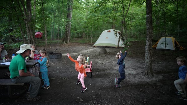 Grandchildren Gus Haschig, 5, takes a sip of water as sister Lydia, 3, cousins Hannah and Daniel Malkovich, 5 and 3, perform some expressive dancing for grandfather Dan Malkovich.]  At William O'Brien State Park exemplifies camping's popularity across the state ballooning as more Minnesotans seek inexpensive, close-to-home vacations and experience the mental and physical health benefits of spending time in nature. (Richard Tsong-Taatarii/Minneapolis Star Tribune/TNS)