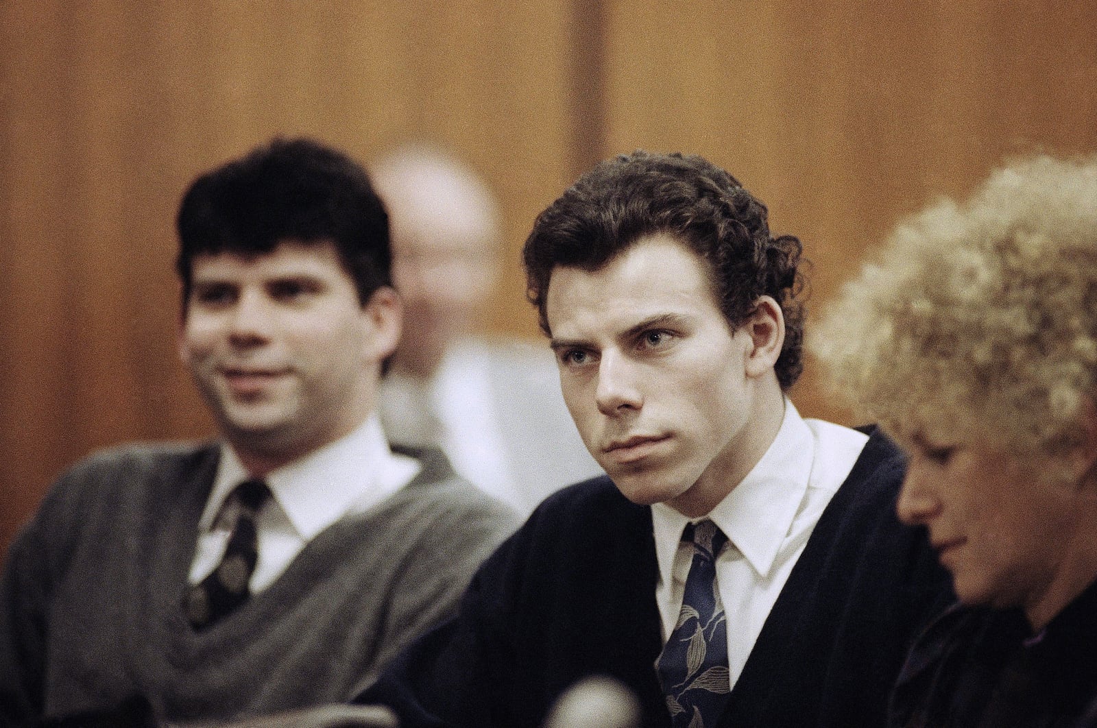 FILE - Lyle, left, and Erik Menendez sit with defense attorney Leslie Abramson, right, in Beverly Hills Municipal Court during a hearing, Nov. 26, 1990. (AP Photo/Nick Ut, File)