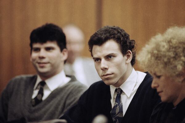 FILE - Lyle, left, and Erik Menendez sit with defense attorney Leslie Abramson, right, in Beverly Hills Municipal Court during a hearing, Nov. 26, 1990. (AP Photo/Nick Ut, File)