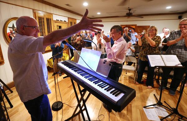 Bruce Gilbert, left, is able to play music and play golf again thanks to an 11-hour brain surgery at Emory. AJC photo: Curtis Compton / ccompton@ajc.com