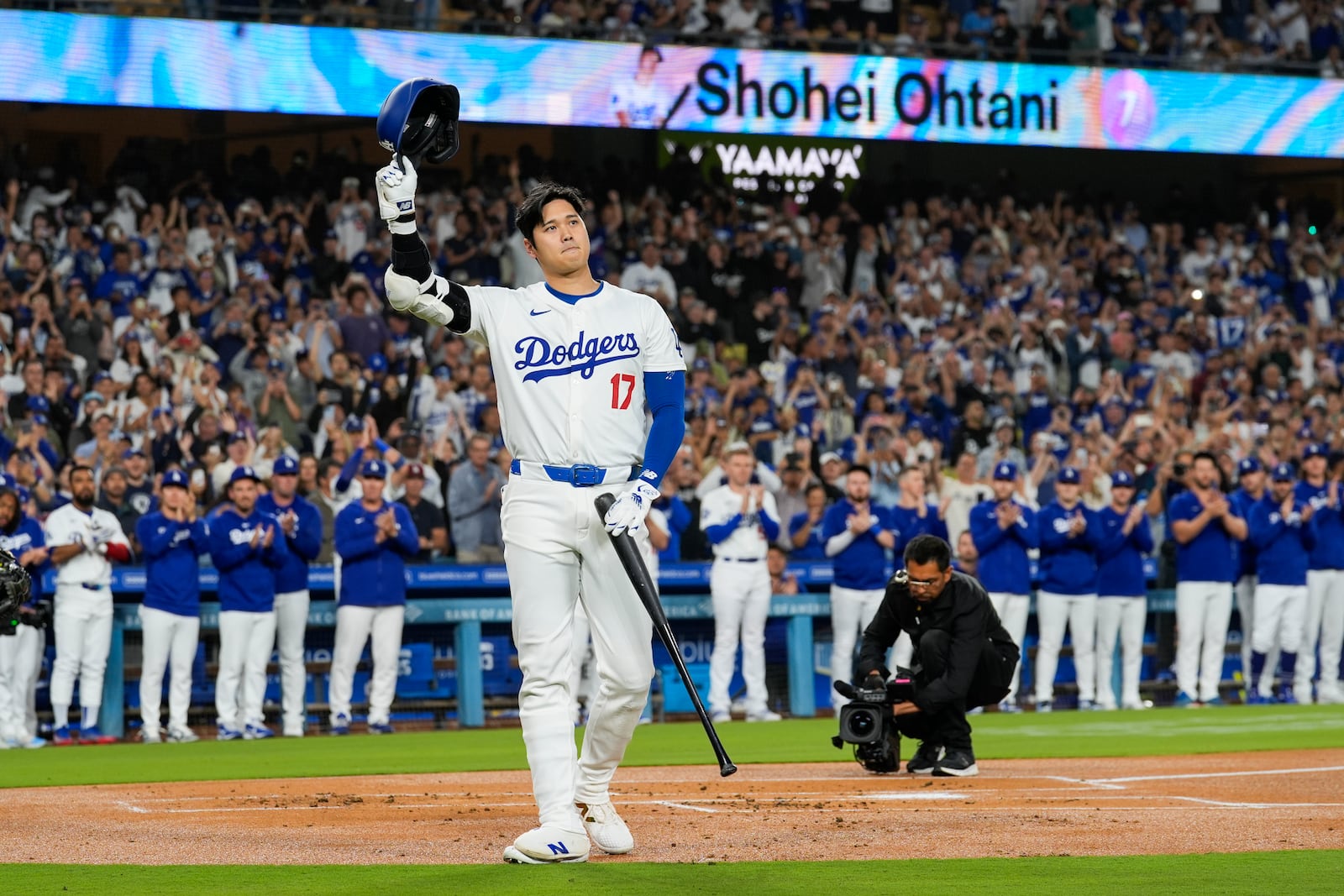 Los Angeles Dodgers designated hitter Shohei Ohtani (17) is honored during the first inning of a baseball game against the Colorado Rockies in Los Angeles, Friday, Sept. 20, 2024. Ohtani was the first MLB player to achieve 50 home runs and 50 stolen bases in a single season. (AP Photo/Ashley Landis)