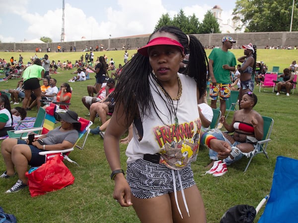 Jgenisius Harris dances to the music in her 1995  Freaknik shirt during the FreakNik 2019 concert at the Cellairis Amphitheatre at Lakewood Saturday, June 22, 2019. Harris said her family went to the 1995 Freaknik and she got the tee shirt.  STEVE SCHAEFER / SPECIAL TO THE AJC