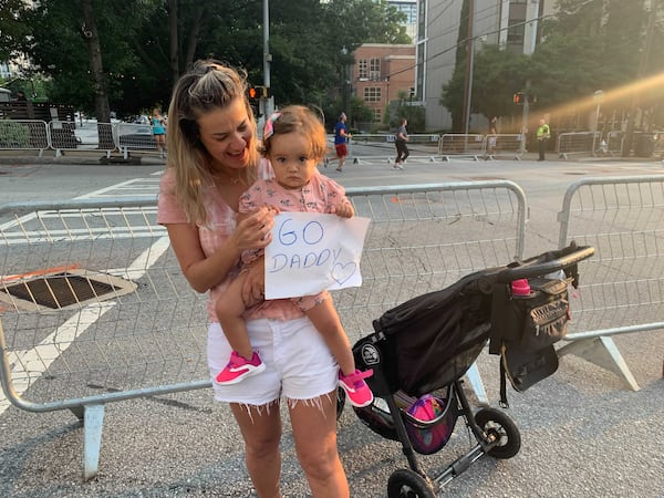 Nayara Castro and daughter Malu cheer on  Rafael Castro on Saturday morning. (Photo: Jeremy Redmon/AJC)