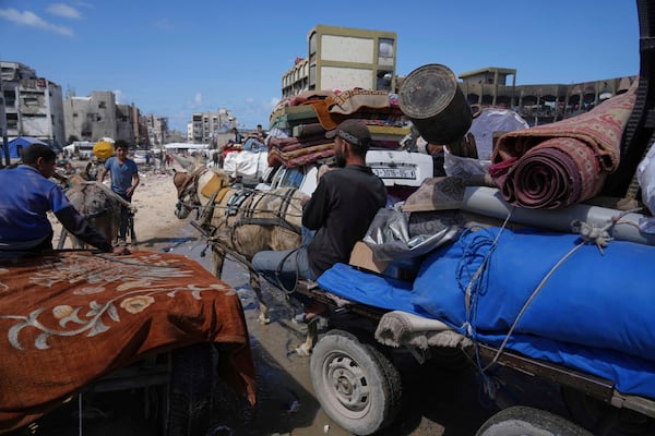 Displaced Palestinians, carrying their belongings traveling from Beit Hanoun to Jabaliya, a day after Israel's renewed offensive in the Gaza Strip, Wednesday, March 19, 2025. (AP Photo/Jehad Alshrafi)