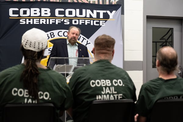 Dan Hydrick, who is a Vietnam veteran, talks to inmates in the Cobb County Jail's honor dorm about services available to them upon release. Ben Gray for the AJC