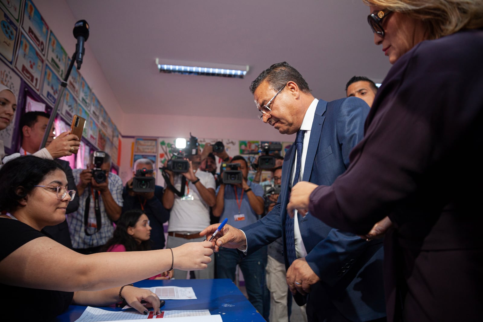 Tunisian President Presidential candidate Zouhair Maghzaoui prepares to cast his vote at a polling station during the presidential elections, in the capital Tunis, Tunisia, Sunday, Oct. 6, 2024. (AP Photo/Ons Abid)