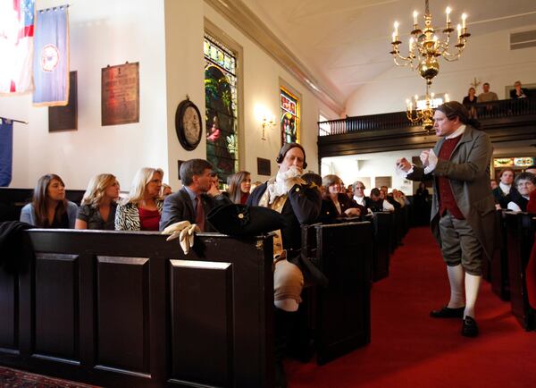 FILE - Virginia Gov.-elect, Bob McDonnell, fourth from left, listens to a speech by Patrick Henry re-enactor, Michael Wells, right, at St.,John's Church in Richmond, Va., on Jan. 15, 2010. (AP Photo/Steve Helber, File)