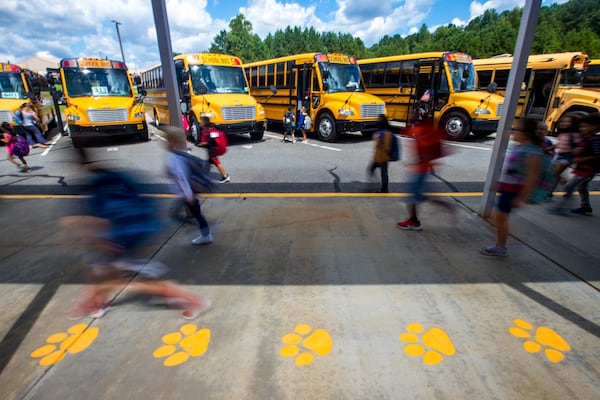 Bus riders at Liberty Elementary School in Canton finish their school day and start their ride home in Cherokee County on Thursday, Sept 2, 2021.  (Jenni Girtman for The Atlanta Journal-Constitution)