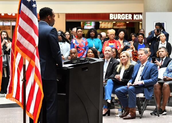 Gov. Brian Kemp looks on as Atlanta Mayor Andre Dickens speaks at a Jan. 31, 2023 event targeting human trafficking. AJC/Hyosub Shin. 