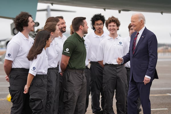 President Joe Biden greets members of AmeriCorps National Civilian Community Corps (NCCC) Southern Region Team Delta 6, as he arrives on Air Force One at Charleston Air Force Base in Charleston, S.C., Sunday, Jan. 19, 2025. (AP Photo/Stephanie Scarbrough)