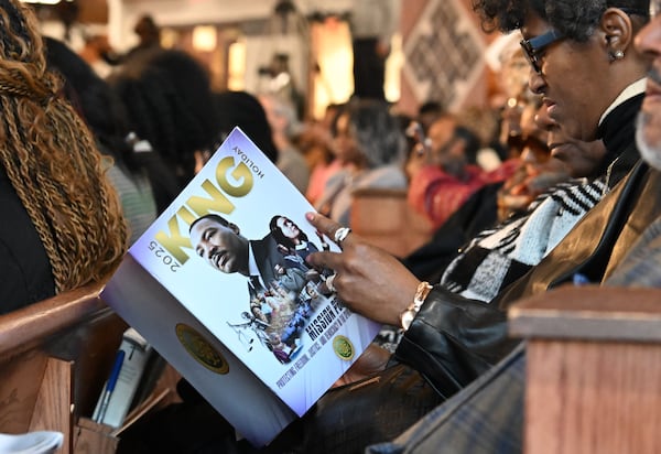 A guest holds a program booklet during the 57th Martin Luther King, Jr. Beloved Community Commemorative Service at Ebenezer Baptist Church, Monday, January 20, 2025, in Atlanta. (Hyosub Shin / AJC)