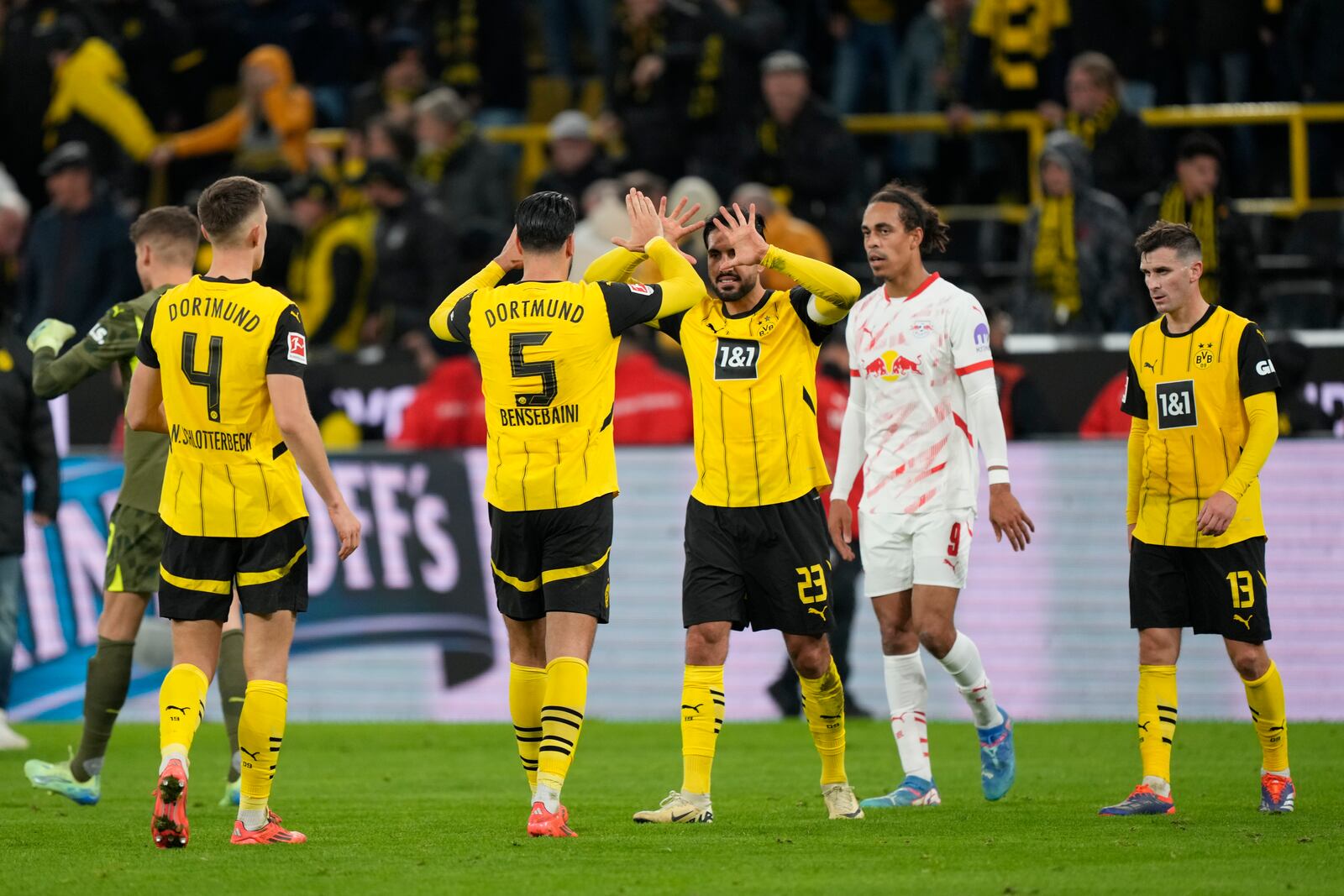 Dortmund players celebrate after winning the German Bundesliga soccer match between Borussia Dortmund and RB Leipzig at the Signal-Iduna Park in Dortmund, Germany, Saturday, Nov. 2, 2024. (AP Photo/Martin Meissner)