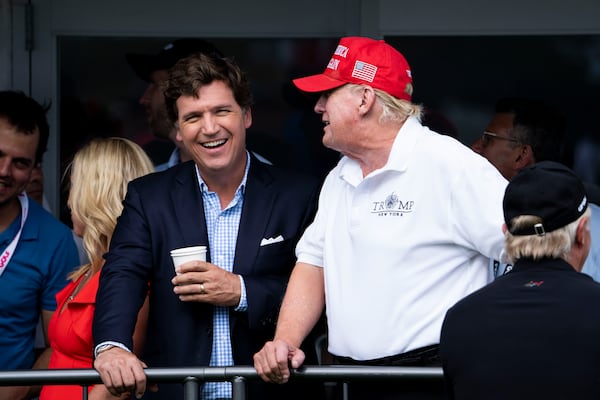 Tucker Carlson and former President Donald Trump at Trump National Golf Club in Bedminster, N.J., July 31, 2022. The duo hopes to upstage the Republican president debate in Milwaukee by posting a pre-taped interview. (Doug Mills/The New York Times)