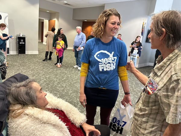 Kim Fitz, mid-day host at Fish 104.7, talks to listeners waiting in line to meet Kevin Avery and Taylor Scott, the morning team, on Saturday, Jan. 25, 2025 for the station's farewell party at Mt. Paran Church in Atlanta. RODNEY HO/rho@ajc.com